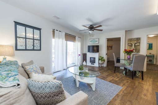 a living room with furniture and a ceiling fan  at Roaring Fork Apartments, Basalt