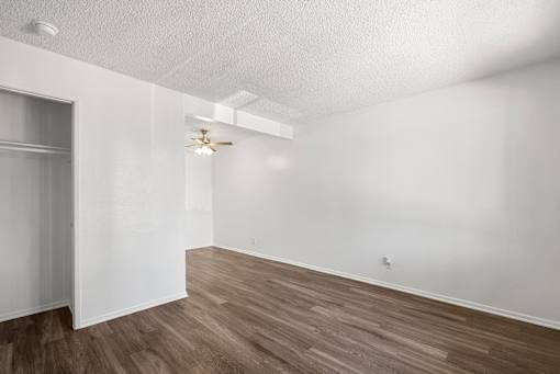 A room with wooden floors and white walls.