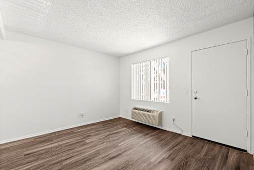 A room with a window and a door.
