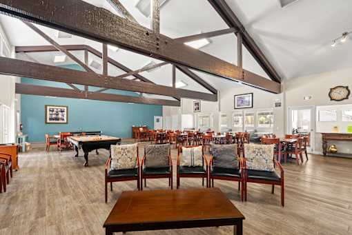 A large room with wooden floors and furniture.
