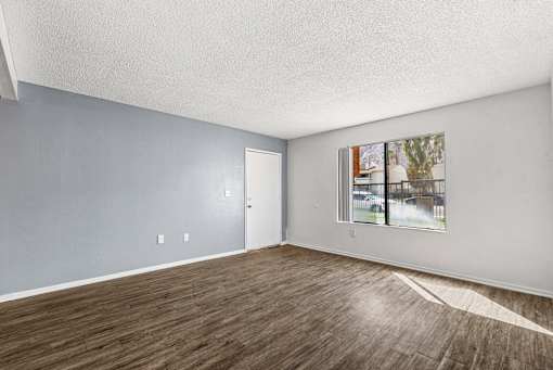 Empty room with wooden floor and white walls.