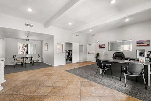 A spacious room with a dining table and chairs.