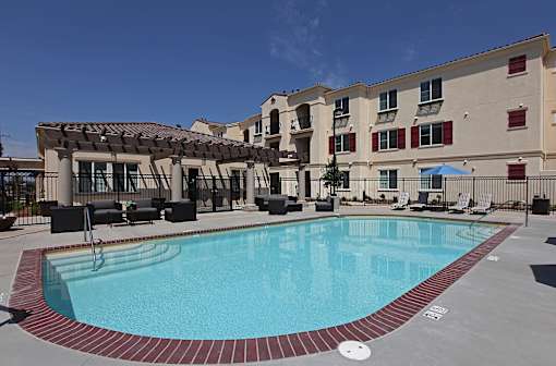 A swimming pool surrounded by a red brick border.