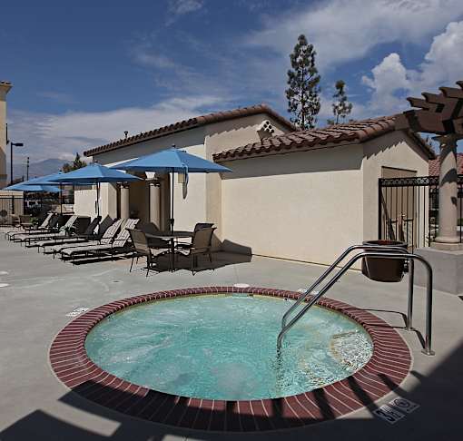 A pool with a hot tub in the middle of it.