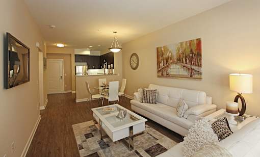 A living room with a white couch and a coffee table.