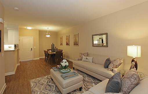 A living room with a couch, coffee table, and a lamp.