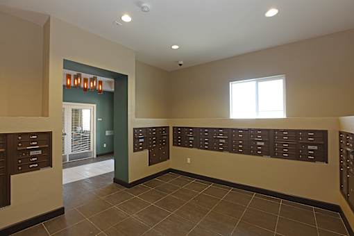 A hallway with a wall of lockers on the right side.