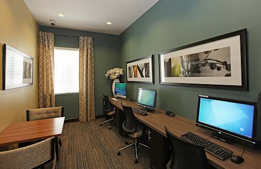 A room with two computers and a table.