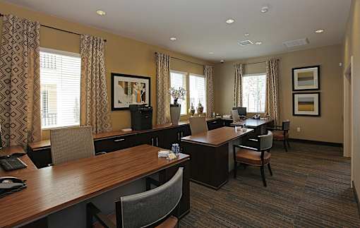 A conference room with a long table and chairs.