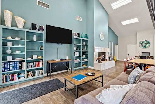 A living room with a fireplace and a television.