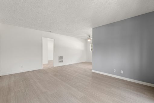 A room with light grey walls and a light brown floor.