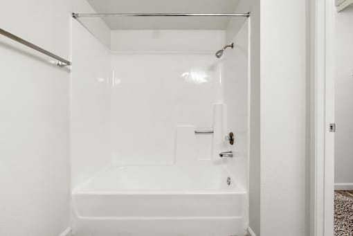 A white bathroom with a bathtub and shower.