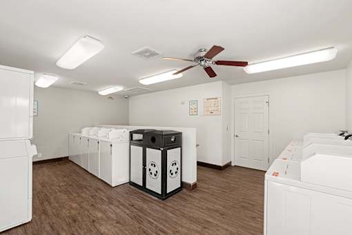 A room with a white ceiling and a black and white fridge.