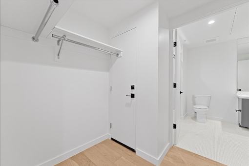 A white bathroom with a toilet and sink.