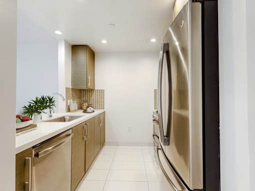 A modern kitchen with a stainless steel refrigerator.