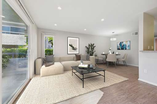 A modern living room with a glass wall and a sofa.