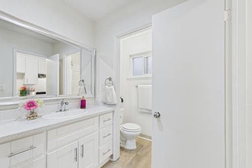 A white bathroom with a toilet and sink.