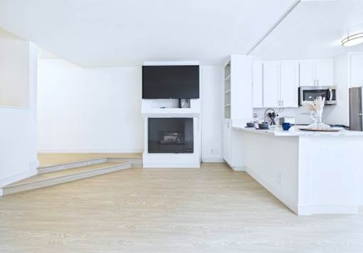 A modern kitchen with a white cabinet and a white island.