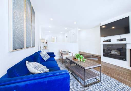A living room with a blue couch and a television.