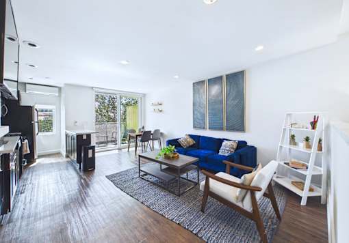 A living room with a blue couch and a television.