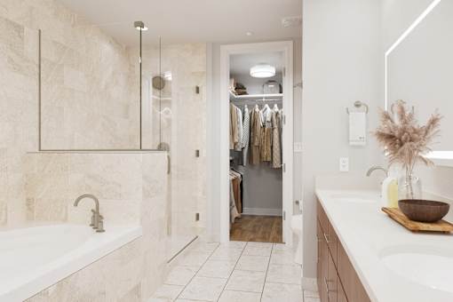 A bathroom with a white tub and a white sink.