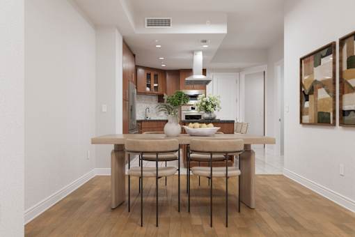 A kitchen with a table and chairs in the middle of the room.