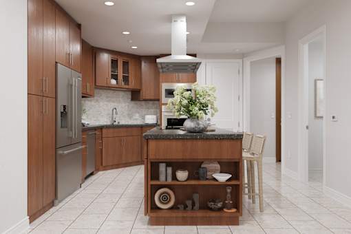 A kitchen with wooden cabinets and a marble countertop.