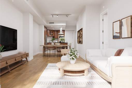 A living room with a white couch and a wooden coffee table.
