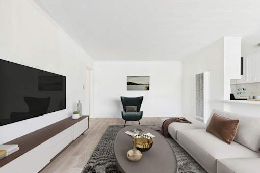 A modern living room with a white sofa, a black chair, and a coffee table.