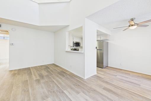 A room with a wooden floor and a ceiling fan.