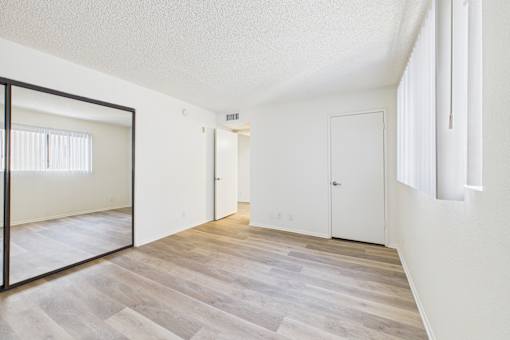 A room with a wooden floor and white walls.