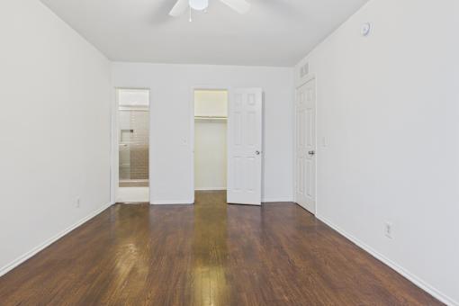 A room with wooden floors and white walls.