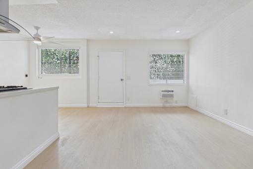 A white room with a door and a window.