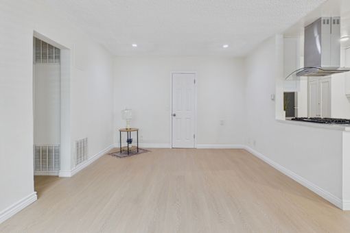 A room with a wooden floor and white walls.