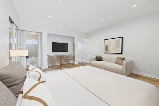 A modern living room with a white sofa and a television.