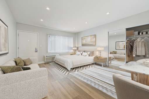 A well-lit bedroom with a large bed and a wardrobe.