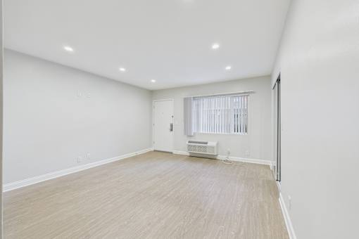 A room with a window and a radiator on the wall.