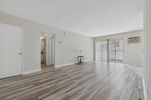 A room with a wooden floor and white walls.