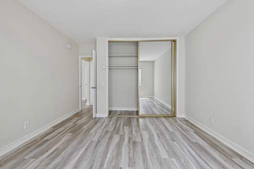 A room with a white door and a white wall.