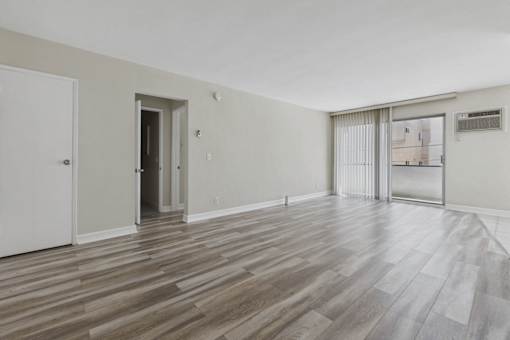 A room with a white door and a window with blinds.