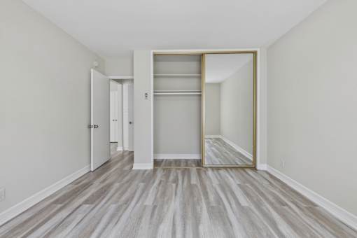 A room with a white door and a white wall.