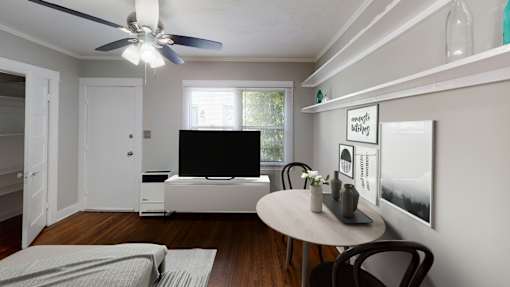 A living room with a white couch and a television.