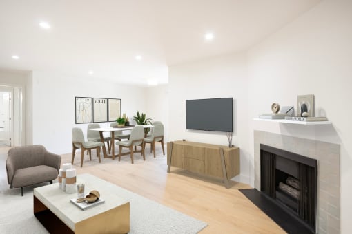 a living room with a fireplace and a table with chairs