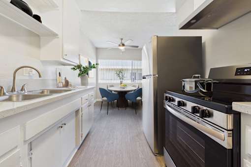 A modern kitchen with a black stove top oven.