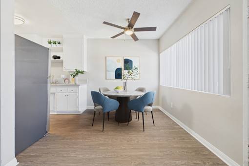 A dining room with a table and chairs.