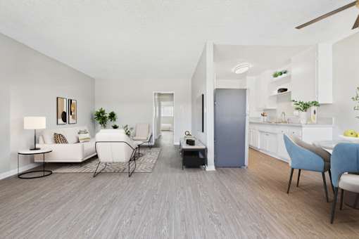 A living room with a grey floor and white walls.