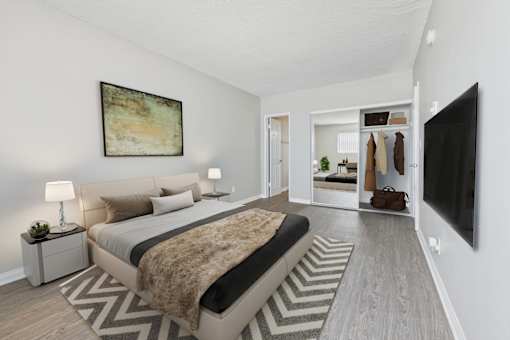 A bedroom with a large bed and a painting on the wall.