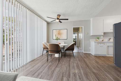 A dining room with a table and chairs.