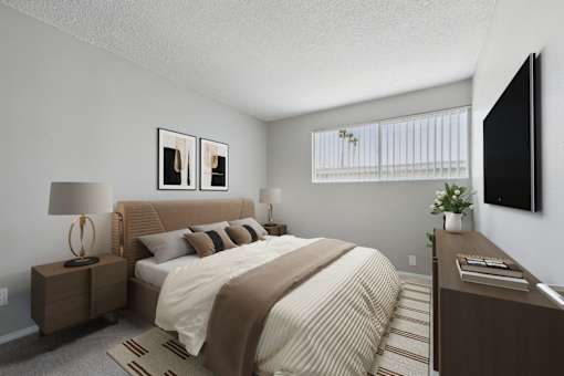 A bedroom with a bed, nightstand, and a television.
