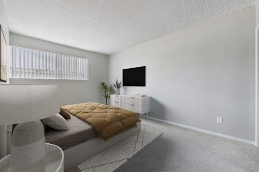 A bedroom with a bed, a chair, and a television.